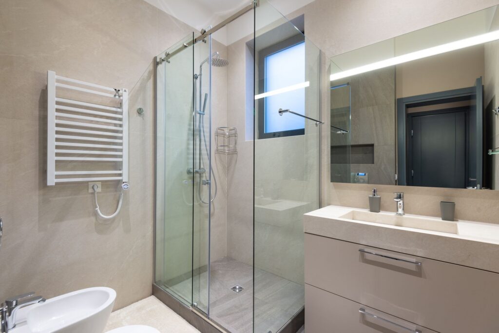 Modern bathroom with a glass shower enclosure, waterproofed under the tiles